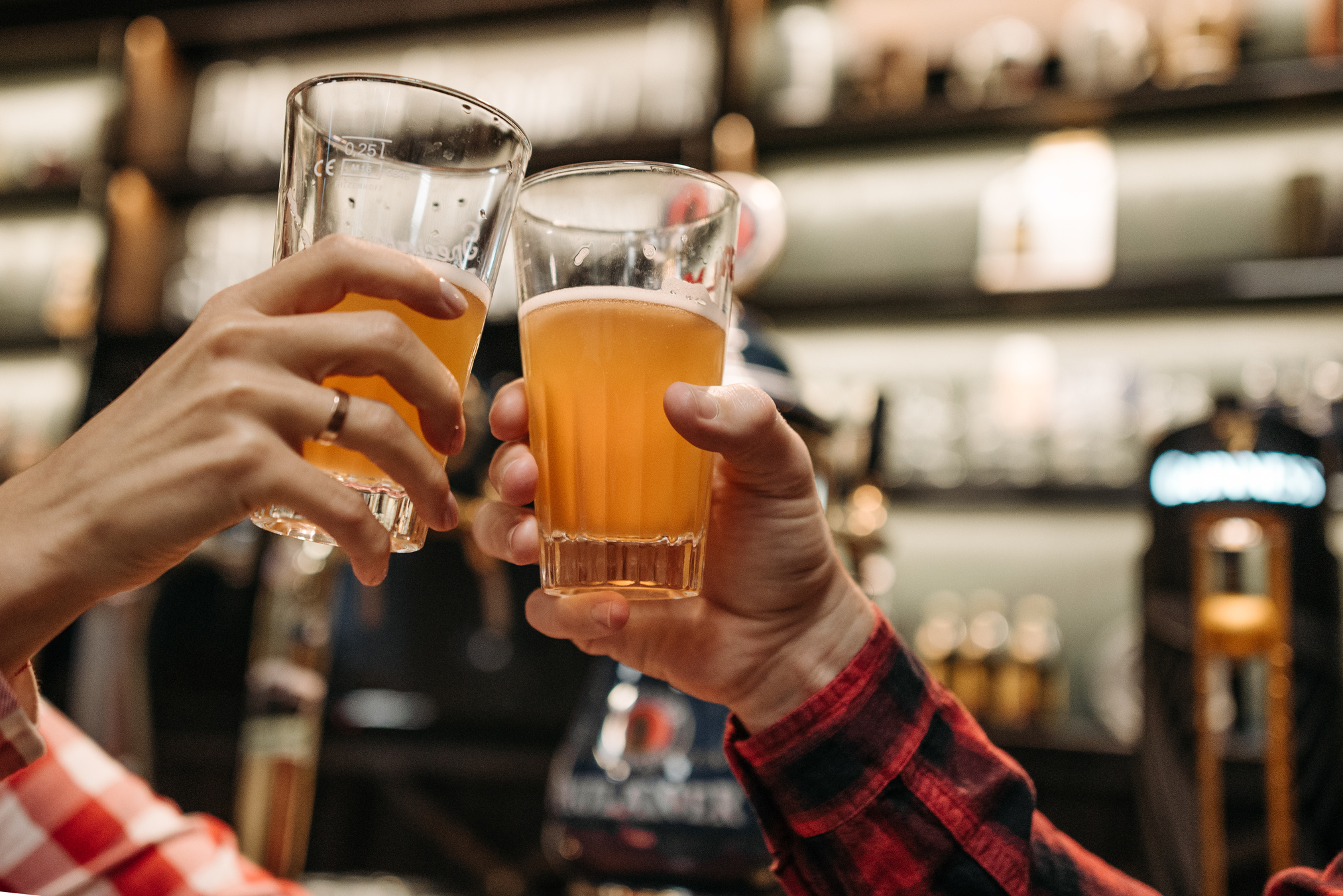 Hands Holding Glasses of Beer